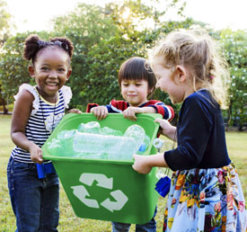 students holding a recycling bin